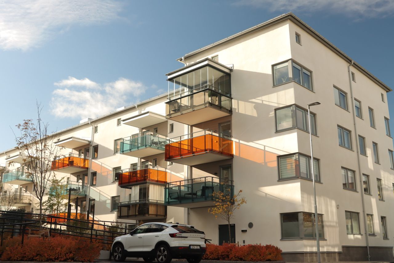 services-01 A modern apartment building in Jönköping, Sweden with stylish balconies and autumn foliage.